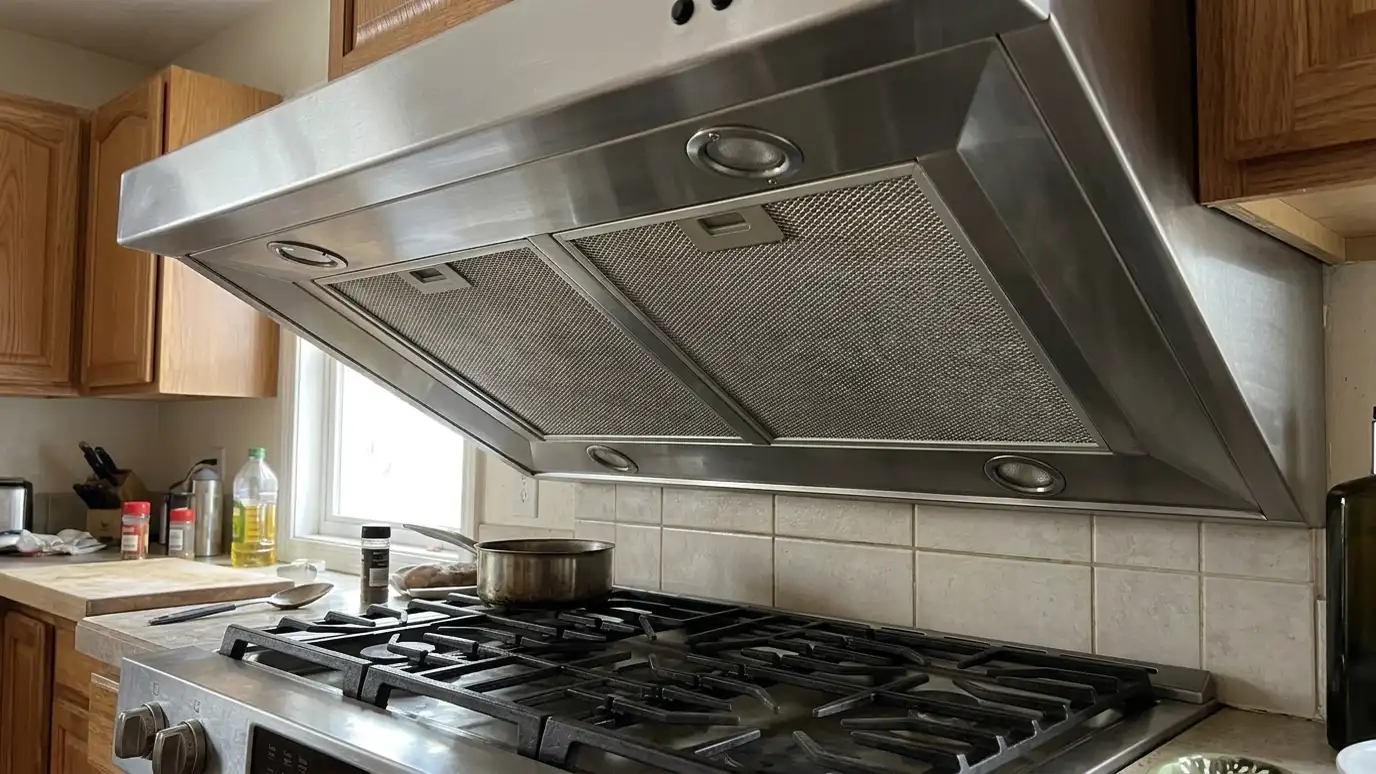 After: A greasy range hood cleaned and shining | Music City Appliance Repairs After: a range hood with a clean, shiny range hood with spotless filters